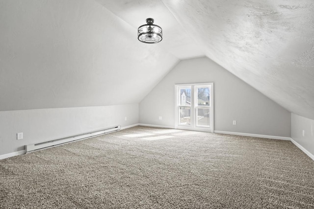 bonus room with a textured ceiling, a baseboard heating unit, carpet floors, baseboards, and vaulted ceiling