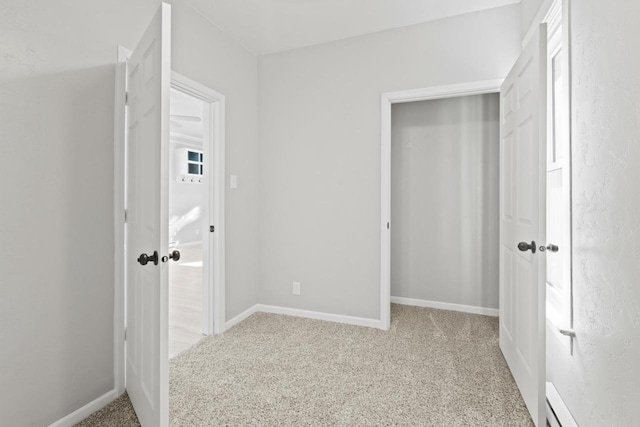 unfurnished bedroom featuring carpet floors, a closet, and baseboards