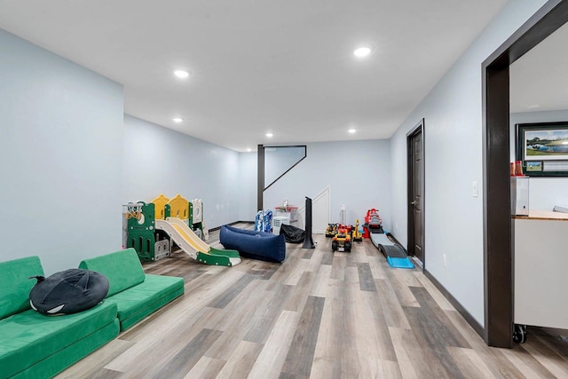 game room with baseboards, light wood-type flooring, and recessed lighting