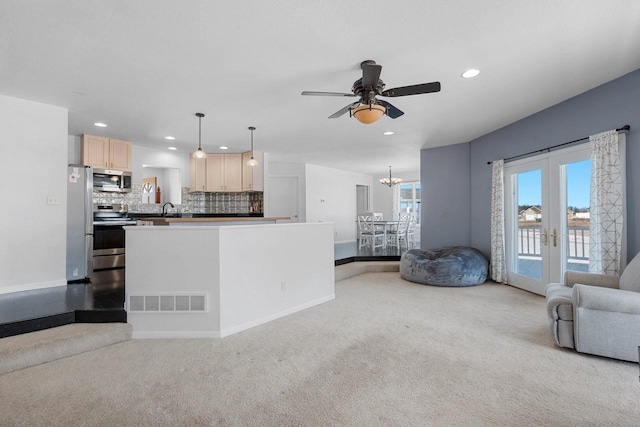 living area with recessed lighting, light carpet, ceiling fan with notable chandelier, visible vents, and french doors