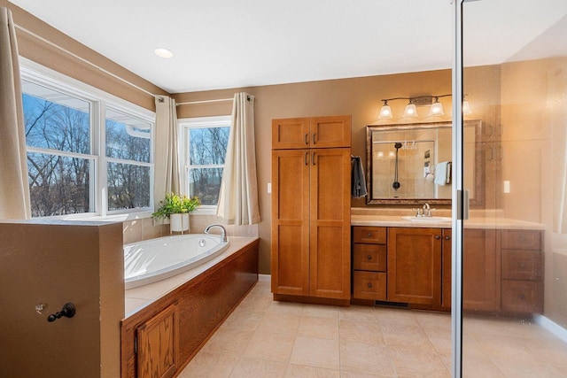 bathroom with a shower, vanity, and a bath