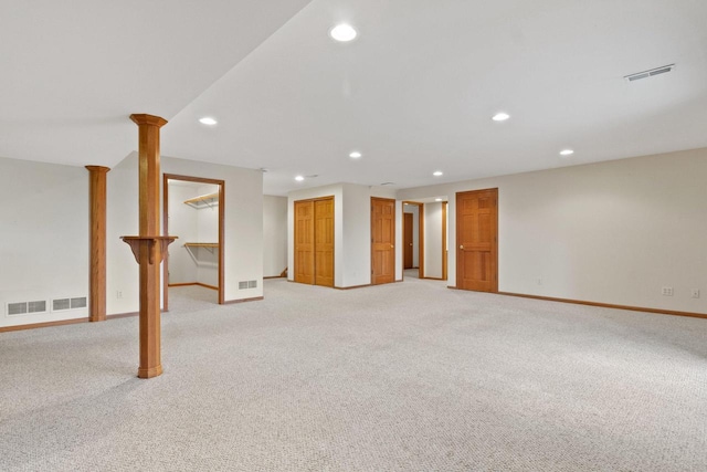 finished basement with recessed lighting, visible vents, baseboards, and light carpet