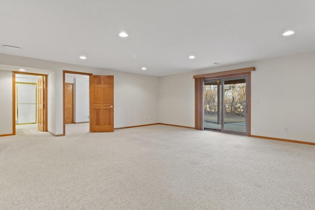 empty room with recessed lighting, light colored carpet, and baseboards