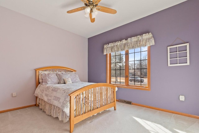 bedroom featuring a ceiling fan, visible vents, carpet, and baseboards