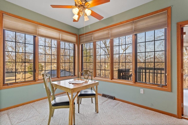 sunroom / solarium featuring a ceiling fan and visible vents