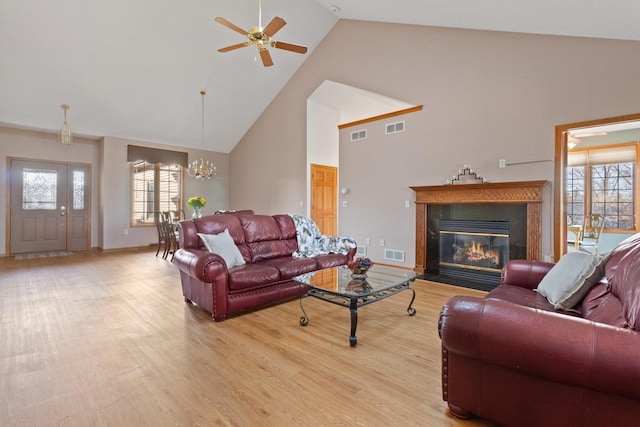 living room featuring light wood finished floors, visible vents, and a wealth of natural light