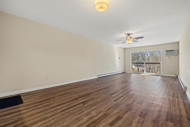 unfurnished living room featuring a baseboard heating unit, a wall unit AC, dark wood finished floors, and baseboards