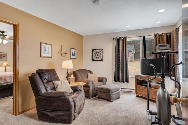 living room featuring a baseboard heating unit, recessed lighting, carpet flooring, and baseboards