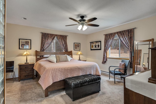 bedroom with a ceiling fan, carpet flooring, and baseboards