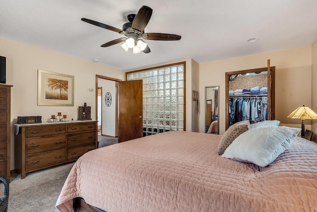 bedroom featuring carpet floors, ceiling fan, a spacious closet, and a closet