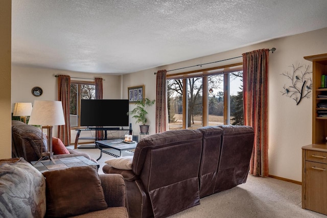 living room featuring light carpet, a textured ceiling, and baseboards