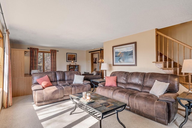 living room featuring carpet and stairway