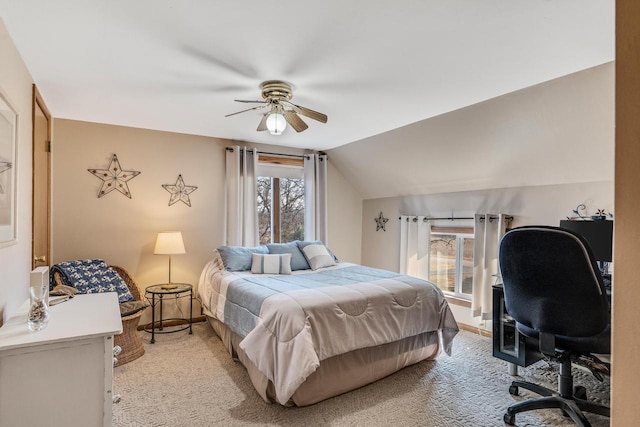 bedroom featuring lofted ceiling, light carpet, and a ceiling fan