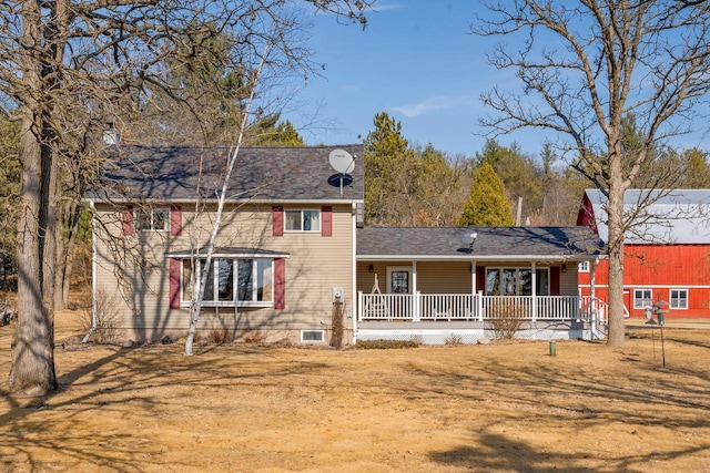 rear view of property with covered porch