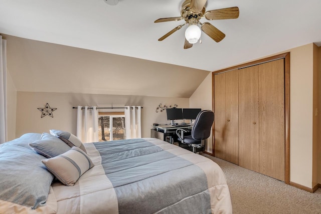 bedroom featuring a closet, light carpet, vaulted ceiling, ceiling fan, and baseboards