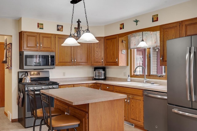 kitchen featuring brown cabinetry, a kitchen island, stainless steel appliances, light countertops, and a sink