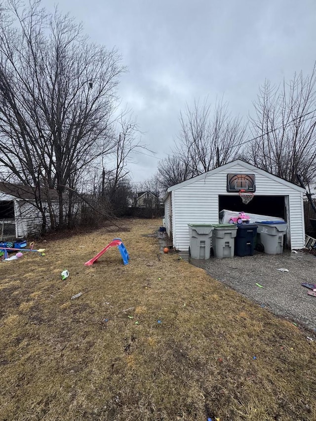 view of yard featuring a garage and an outdoor structure