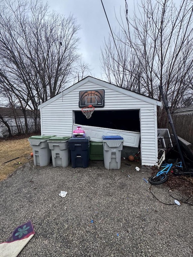 view of outbuilding featuring an outdoor structure and fence