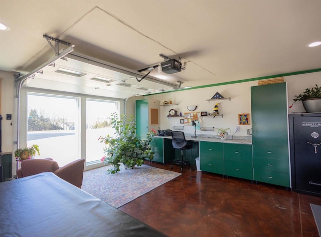 interior space featuring a garage, finished concrete floors, and recessed lighting