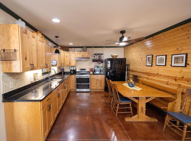 kitchen with ceiling fan, under cabinet range hood, stainless steel appliances, wood walls, and a sink