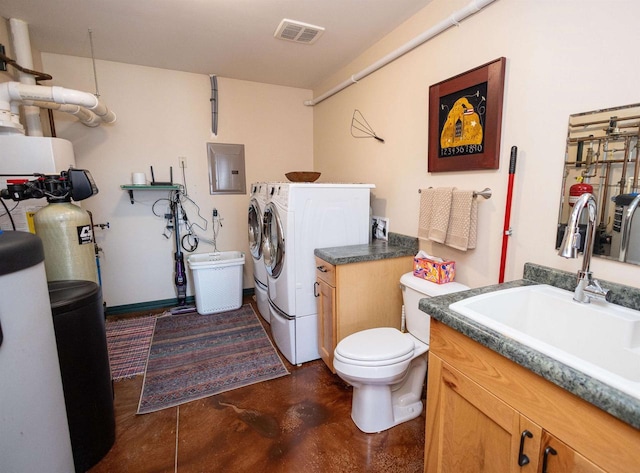 bathroom with electric panel, visible vents, concrete flooring, vanity, and washer and dryer