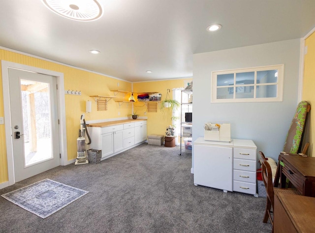 kitchen with recessed lighting, light countertops, dark carpet, visible vents, and white cabinetry