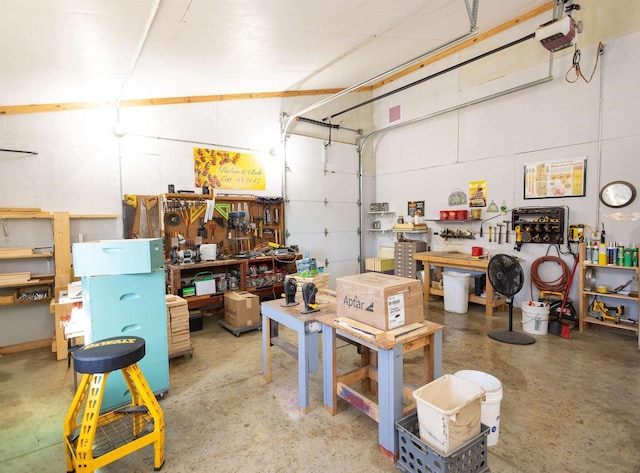 garage with a workshop area and a garage door opener