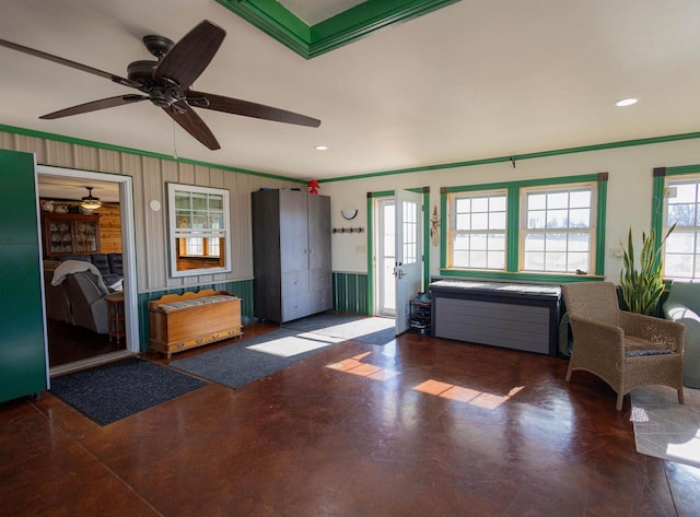 entryway with finished concrete flooring, crown molding, and recessed lighting