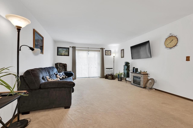 living area featuring carpet floors, a fireplace, and baseboards