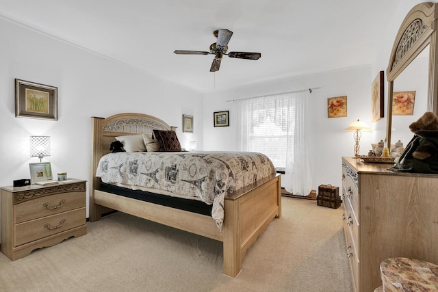 bedroom with a ceiling fan and light colored carpet