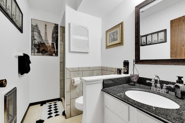 full bath featuring toilet, tile patterned floors, heating unit, walk in shower, and vanity