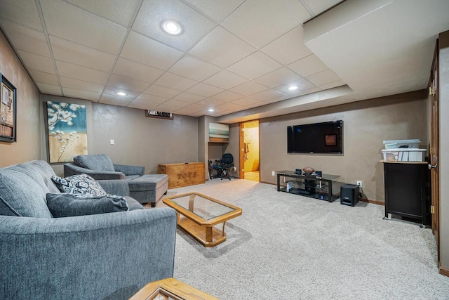 living room featuring baseboards, a drop ceiling, carpet flooring, and recessed lighting