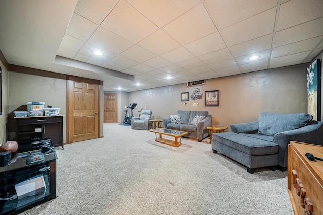 carpeted living area featuring recessed lighting and a drop ceiling