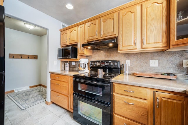 kitchen featuring light countertops, stainless steel microwave, decorative backsplash, double oven range, and under cabinet range hood