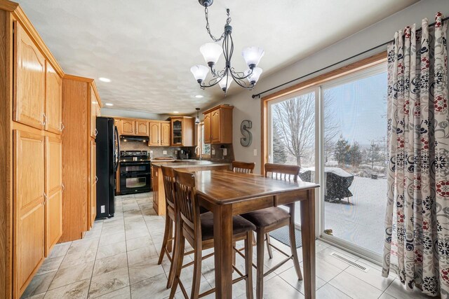 dining space with visible vents, a notable chandelier, and recessed lighting