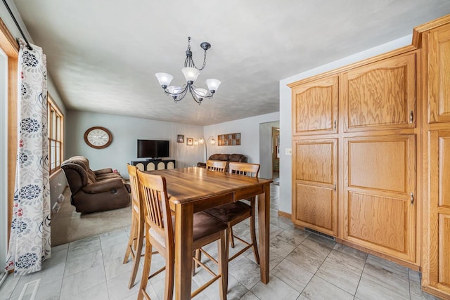 dining room with a notable chandelier