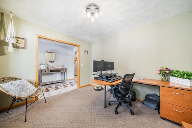 office space featuring baseboards and light colored carpet