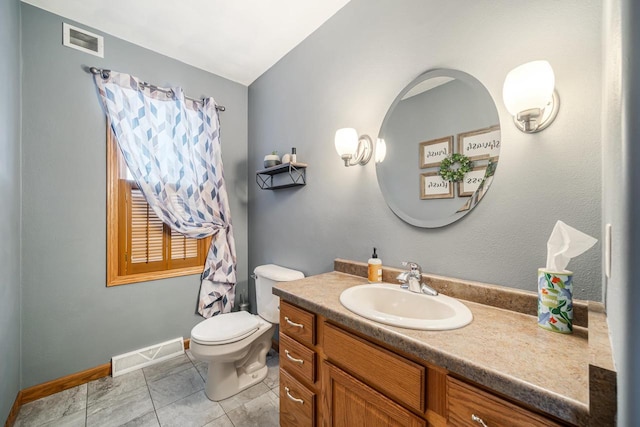 bathroom featuring toilet, vanity, visible vents, and baseboards