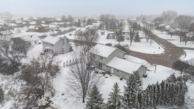 snowy aerial view featuring a residential view