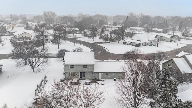 snowy aerial view featuring a residential view