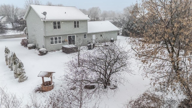 snow covered property with a fire pit