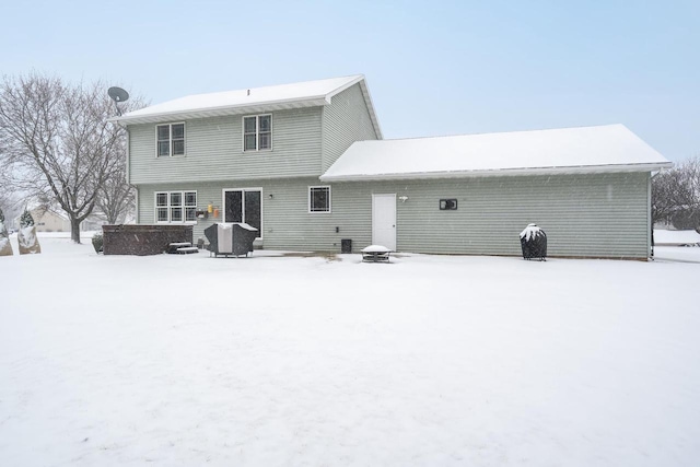 snow covered property featuring an outdoor fire pit