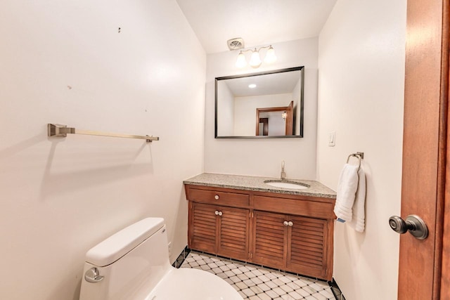 bathroom featuring visible vents, vanity, and toilet