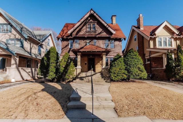 craftsman-style home with brick siding