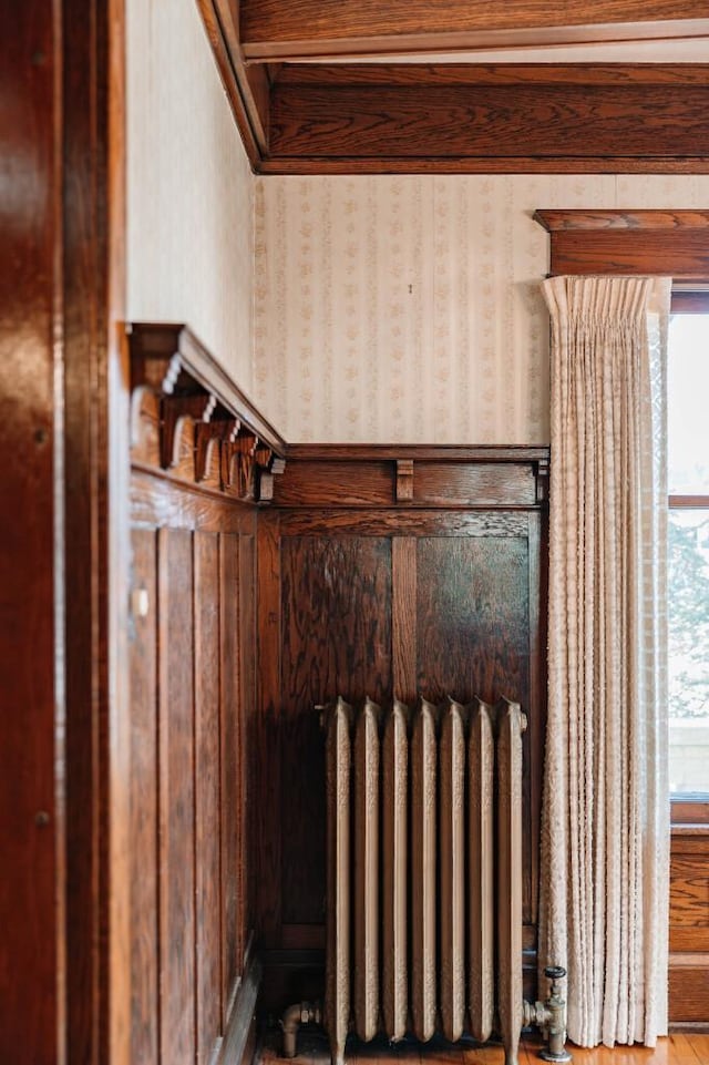 room details featuring wallpapered walls and radiator