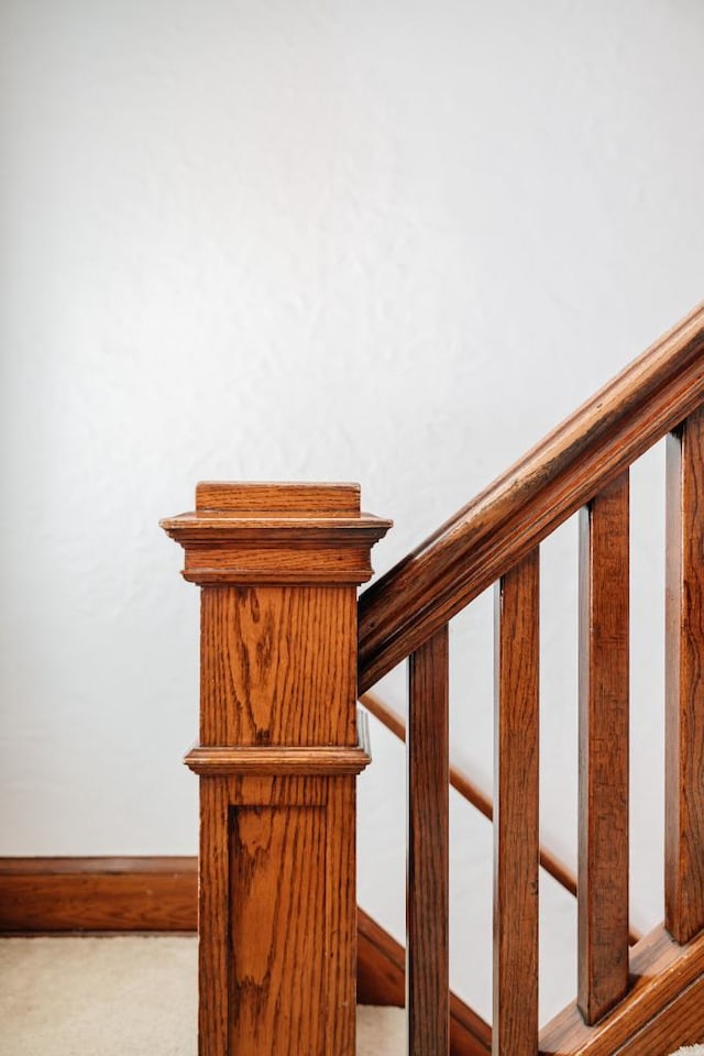 staircase featuring carpet and baseboards