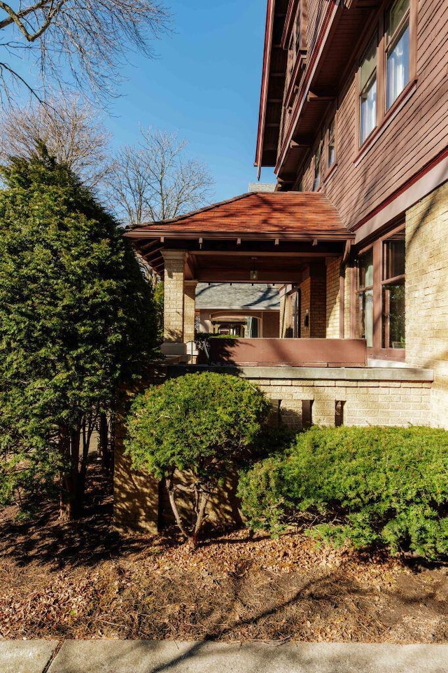 view of side of home with brick siding