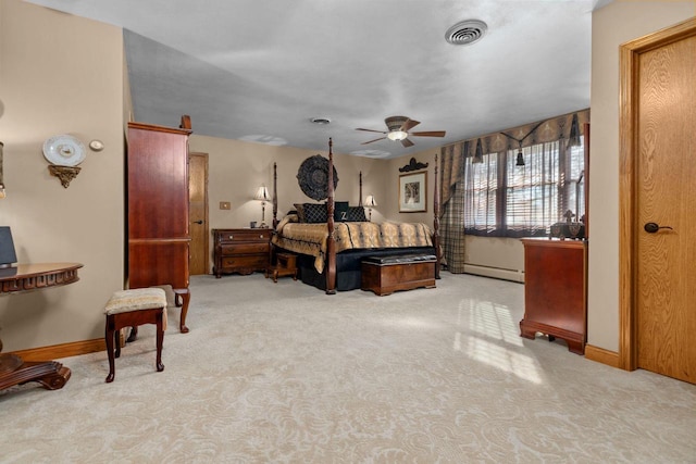 carpeted bedroom featuring baseboard heating, visible vents, and baseboards