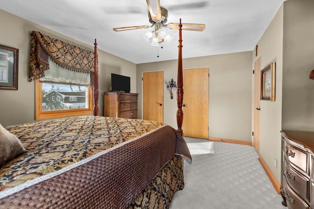 carpeted bedroom featuring ceiling fan, baseboards, and multiple closets