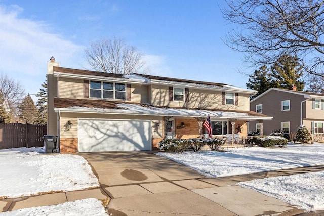 traditional home featuring driveway, a chimney, covered porch, fence, and brick siding